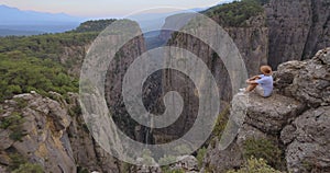 Tourist man on the edge of the mountain cliff of Tazi Canyon in Manavgat, Antalya, Turkey. Greyhound Canyon, Wisdom