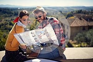 Tourist man and girl using map as guide on journey time