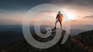 Tourist man hiker on top of the mountain. Active life concept photo