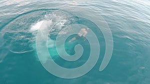 Tourist man jumping in water from yacht