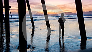 Tourist man looking sunset at Pismo beach, California