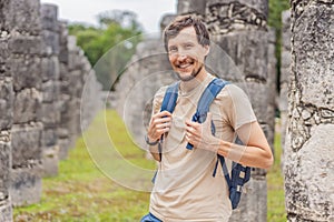 tourist man observing the old pyramid and temple of the castle of the Mayan architecture known as Chichen Itza these are