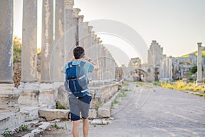 Tourist man at the ruins of ancient city of Perge near Antalya Turkey photo