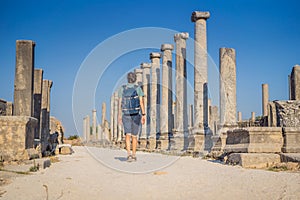 Tourist man at the ruins of ancient city of Perge near Antalya Turkey photo