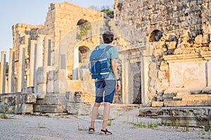 Tourist man at the ruins of ancient city of Perge near Antalya Turkey photo