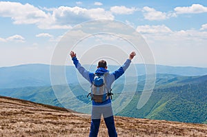 Tourist, man and success in mountains, arms raised