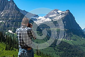 Tourist man taking pictures in Glacier National Park in Montana