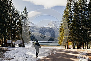 Tourist man travel to snowy mountains background