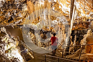 Tourist man in the underground cave, stalactites and stalagmites. `Oylat Cave` Bursa, Turkey