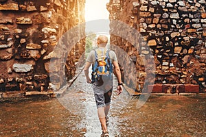 Tourist man walking by the Qutb Minar ruines streets