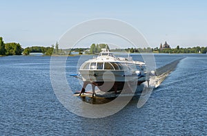 Tourist motor ship Meteor hydrofoils floating on Lake Onega against the background of the Kizhi Historical Park