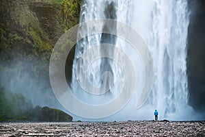 Tourist near Skogafoss waterfall in Iceland