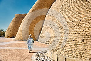 Tourist near Walls of the Ark of Bukhara in Uzbekistan