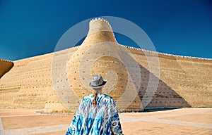 Tourist near Walls of the Ark of Bukhara in Uzbekistan