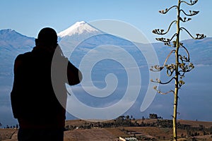 Tourist observing majestic Cotopaxi volcano in