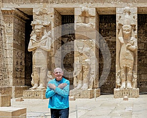 Tourist & Osiride statues of Ramesses III being attended to by little queens on the right side of the first court of his Temple.