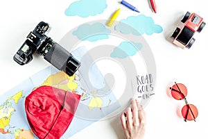 Tourist outfit, camera and map for trip with kids white background top view mockup