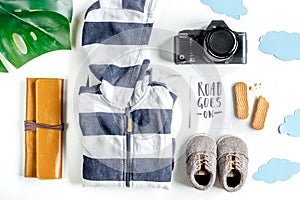 Tourist outfit, clothes and camera for trip with kids white background top view