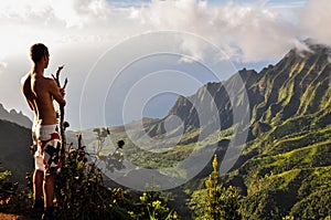 Tourist overlooking Kalalau Valley - Kauai, Hawaii