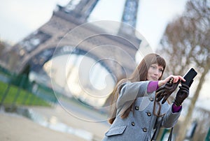 Tourist in Paris taking a picture of herself