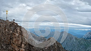 Tourist on the peak of Zugspitze mountain. Hiking and active life concept