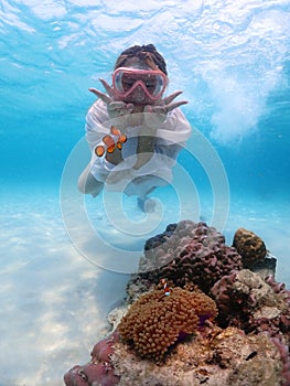 Tourist people diving with snorkel to see nemo fish , beautiful fish and coral at Samaesarn Island of Thailand