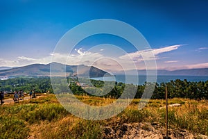 Tourist peoples using paid binocular and observing the beautiful view of Lake Sevan from the top of Sevanavank Mountain