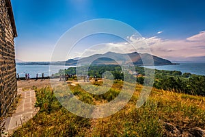 Tourist peoples using paid binocular and observing the beautiful view of Lake Sevan from the top of Sevanavank Mountain