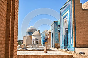 Tourist in Mausoleums of the Shakhi Zinda complex in Samarkand, Uzbekistan photo