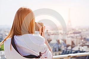 Tourist photographer in Paris taking photo of Eiffel tower