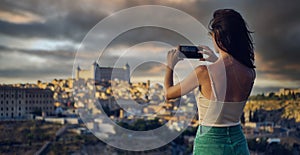 Tourist photographing famous landmarks of Toledo. Spain