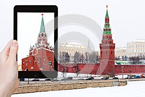 Tourist photographs Kremlin in winter snowing day