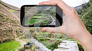 tourist photographs terraced fields in Dazhai