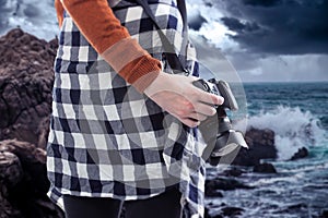 Tourist or Photography Hobbyist Holding Camera at the Coastline