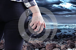 Tourist or Photography Hobbyist Holding Camera at the Coastline