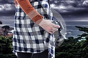 Tourist or Photography Hobbyist Holding Camera at the Coastline