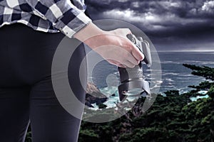 Tourist or Photography Hobbyist Holding Camera at the Coastline