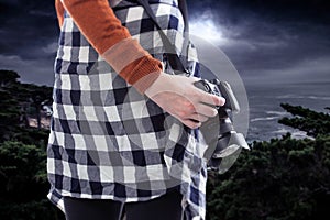 Tourist or Photography Hobbyist Holding Camera at the Coastline