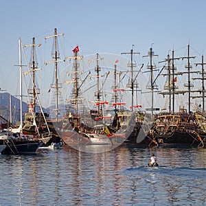 Tourist pirate sailing ships near the pier in the Mediterranean Sea. Port of Kemer, Turkey