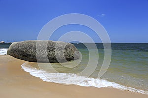 Tourist playing parasail at rock beach