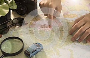 Tourist pointing on the world map for planning vacation