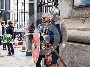 Tourist poses with costumed historic soldier outside British Mus