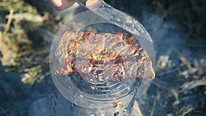 Tourist prepares meat steak in nature in the winter, survival.