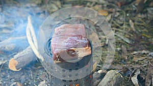 Tourist prepares meat steak in nature in the winter, survival.