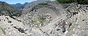 Tourist in red t-shirt are standing in ancient theatre at Termessos