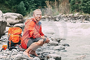 Tourist refresh on the mountain river bank