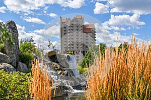 The tourist resort hotel in Coeur d`Alene Idaho rises above the memorial waterfall and pond in McEuen Park