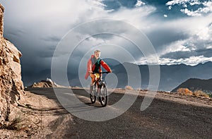 Tourist rides bike on road in Himalaya Mountain