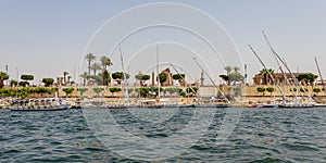 Tourist riverboats with national flags cruising on the Nile in Luxor, Egypt