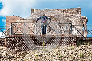 Tourist in Rome, observing a Roman ruin. Imperial Forums.